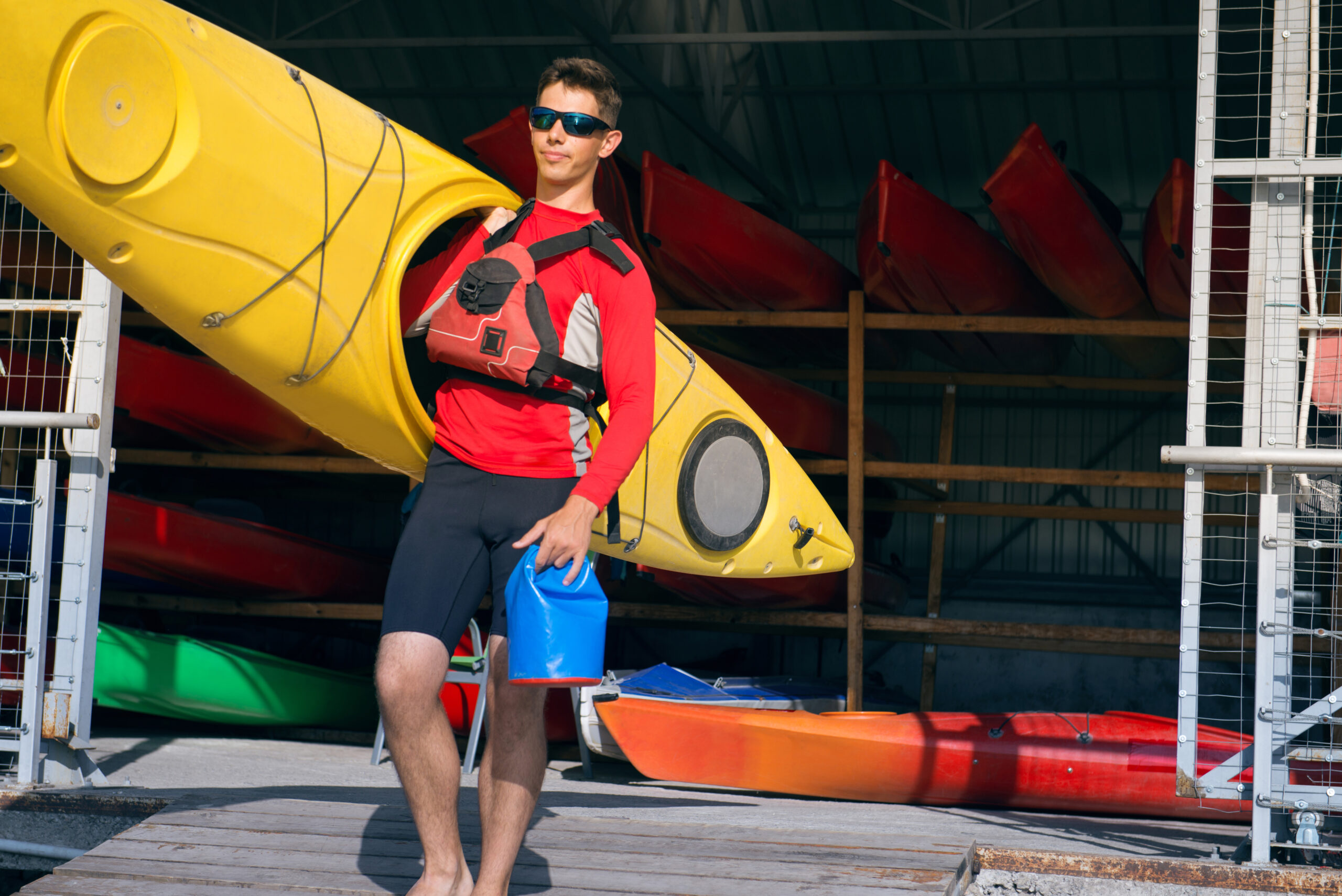 man holding kayak